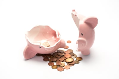 Pink piggy bank broken with money