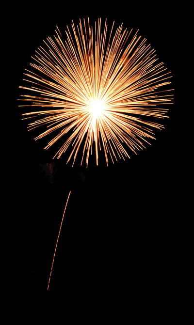 Single burst of yellowish-orange fireworks with thin rocket trail